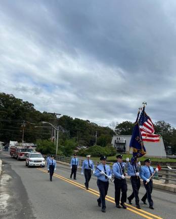 Members of the Stanhope Fire Department march in the parade.