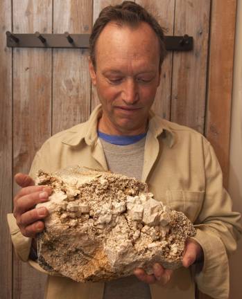 Treasure hunt Glenn Rhein displaying one of his mineral rock collection at his home in Amity