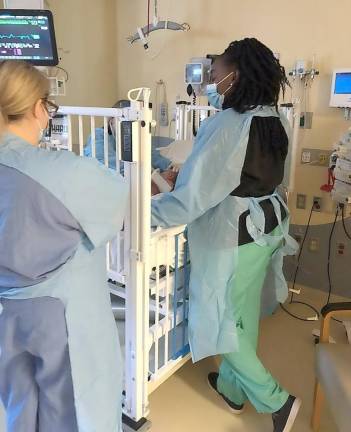 From the depths of isolation: A mother sees COVID-19 from the frontlines Nurses and a doctor (in green pants) in the isolation unit just before Brittany and her son were able to leave it.