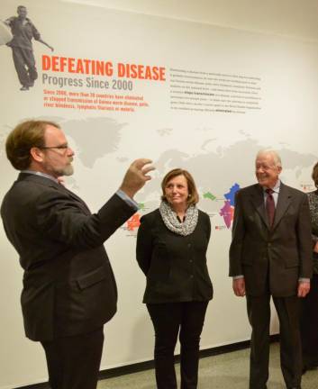 President Ellen Futter of the American Museum of Natural History (center) with former President Jimmy Carter, at the 2015 AMNH exhibition from the Carter Center. (Photo: American Museum of Natural History)