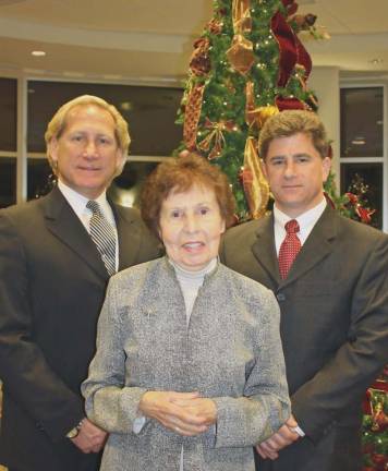 Louis Ruggiero, President of Iliff-Ruggiero Funeral Home; Julia Quinlan, Co-Founder and President of Karen Ann Quinlan Hospice; and Domenick Ruggiero, Manager of Iliff-Ruggiero Funeral Home gather at a former Lights of Life Tree Lighting Memorial Service at Sussex County Community College to embrace area families with this thoughtful holiday tradition.