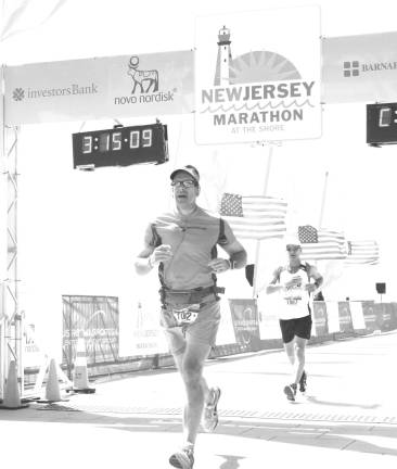 Local to run 140 miles for MS Ken Grisback crossing the finish line at the New Jersey Marathon on May 5.