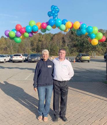 Cathy Kut from Realty Executives poses with John Quinlan, director of bereavement, at last year’s Celebrate A Life Walk. Cut and Realty Executives has sponsored the starting gate balloon arch for the past four years. (Photo provided)