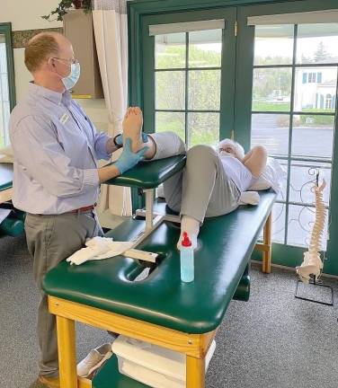Joe Allison ,director and therapist at Drayer Physical Therapy, works with a patient