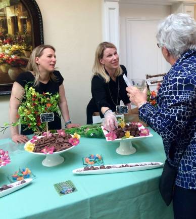 Chocolate Goat has Mother's Day covered The Koza sisters (from left, Jennifer and Stephanie), owners of the Chocolate Goat, talk to a guest at a Project Self-Sufficiency fundraiser. Photos by Laurie Gordon