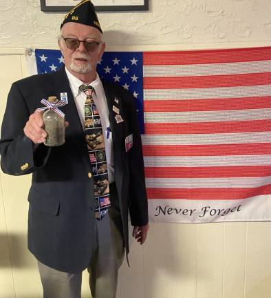 Harry Kaplan, a former commander of American Legion Post 86 in Andover, presents Jacob Yanoff with volcanic ash from Iwo Jima.