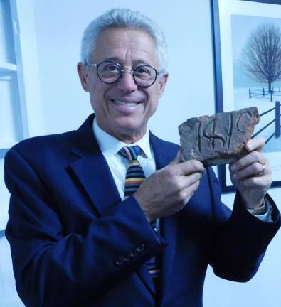 Law firm rededicates building to begin new venture Attorney Mark Gruber shows off an original 1818 brick from the building he and his law partners have renovated from their former offices into a an office cooperative. Gruber toured guests around the building ahead of a rededication ceremony on Tuesday, Nov 12, 2019.