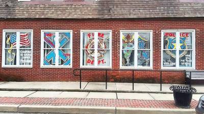 Bathing Beauties, in Ogdensburg, honored frontline workers by having artist Kim Lonsky paint its windows