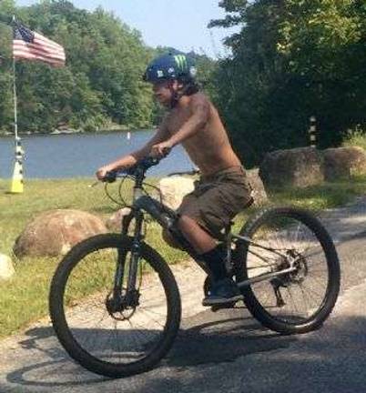 Connor Hannah, of Hampton, zips in from the bike portion of the High Noon Triathlon.