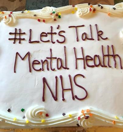 The cake that helped mark the occasion of the Newton High School Green Room for student mental health wellness has a special message: Let's talk mental health.