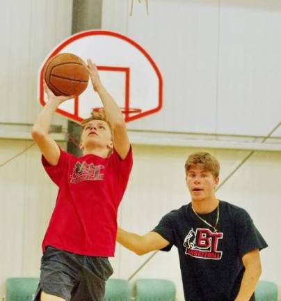 Thirteen year old Grant Krueger of Hampton Township, is in the midst of a lay-up shot after getting past B.T. Basketball staff member Alex Podolski playing defense. Podolski is a graduate of Sparta High School where he played basketball.