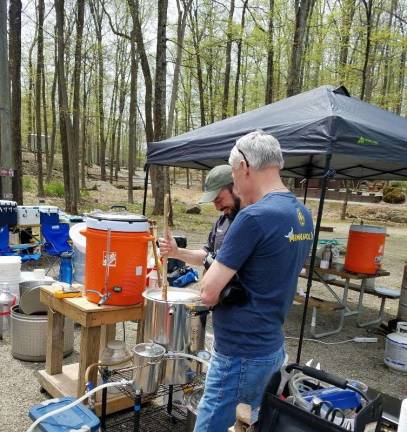 Homebrewers take their craft camping Homebrewers Rob Giaquinta and Paul West share a laugh as Giaquinta prepares a batch of mash for brewing.
