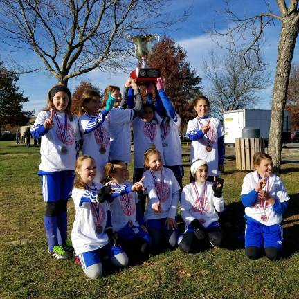 Soccer club builds skills on and off the field Kittatinny Soccer Club's Kittatinny United U12 Girls Team holding up the trophy won last season at the Morris County Youth Soccer Association League Cup.