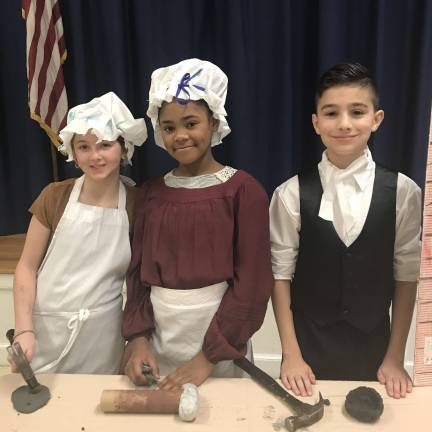 Students learn by living the life of the Colonists Blacksmiths Saffron Bessler, Kinya Kajogo and Jared Begraft Photos by Laurie Gordon