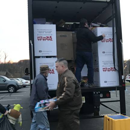 More elves unloading goods at Project Self-Sufficiency in Newton