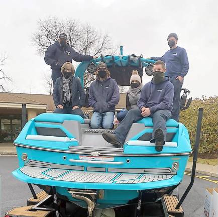 Sherri and Lou Cecchini, along with staff from Off Shore Marine, with their 2020 Stuff the Boat project (Photo by Laurie Gordon)