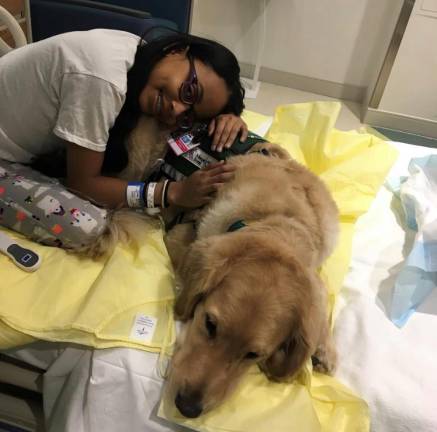 Providing Some Fun in a Child’s Hospital Stay Kayla snuggling with Amos. (Photo: Mount Sinai Kravis Children’s Hospital)