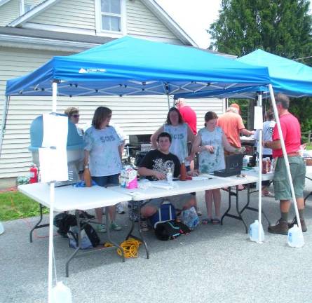 Music, fireworks and fun at Andover Township Day Members and families of Girl Scout Troop 5015 of Green Township prepare cotton candy, burgers, and hot dogs for sale at Andover Township Day