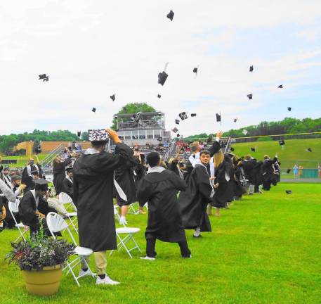 ‘All eyes are on the Class of 2020’ Students throw their caps in the air. (Photo by Vera Olinsky)
