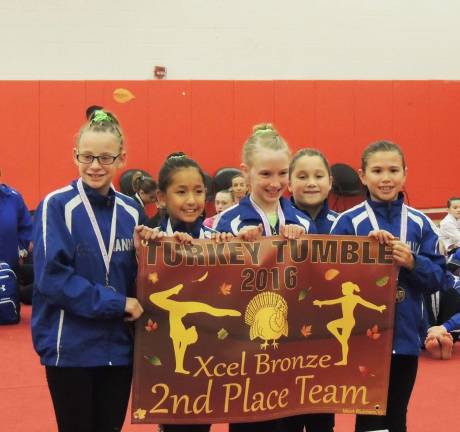 Giant Gymnastics Xcel teams power through first meet From left, Hannah Lounsbury, Victoria Ciliberti and Emma Hamilton of Sparta, Lilly Sauchelli of Newton and Milly Dobbs of Sparta — the second place bronze team