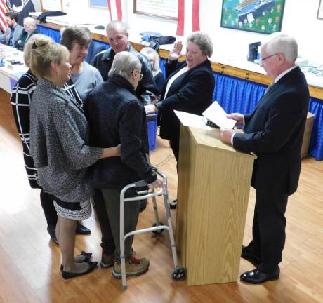 New Stanhope Mayor Patricia Zdichocki (center) takes the oath of office Sussex County Clerk Jeff Parrott as her family holds the bible on Tuesday, Jan 7, 2020, at American Legion Post 278 of Stanhope.