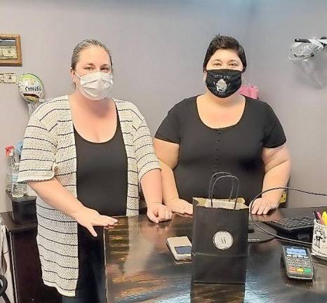 Sisters Lisa Russinko (left) and Heather Russinko stand behind their custom-made sales counter at their new confectionery supply shop, Sugar Sisters, located on Main Street in Franklin (Photo by Mandy Coriston)