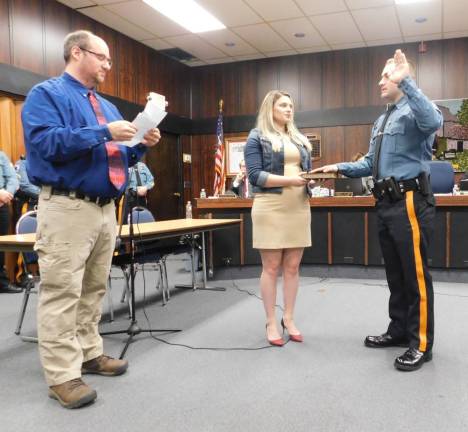 (L-R) Byram Mayor Alex Rubenstein reads the oath of service while Christy Smetana holds the bible, as William Underwood becomes a member of the Byram Township Police Department on Tuesday, Jan 7, 2020.