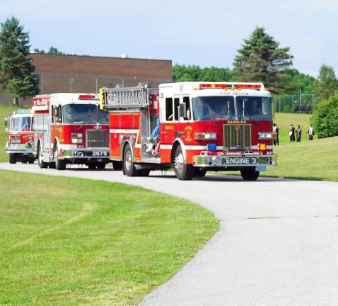 ‘All eyes are on the Class of 2020’ Local police and fire departments escort students to their in-person graduation. (Photo by Vera Olinsky)