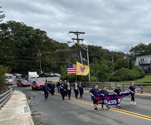 Members of the Pochuck Valley Volunteer Fire Department in Sussex march in the parade.