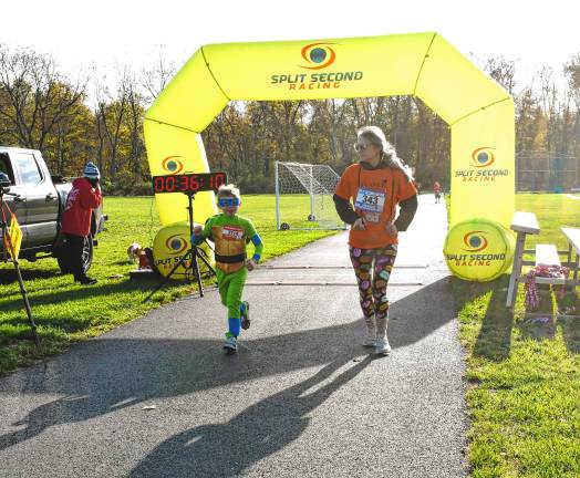Photos: Haunted Hawk Hustle 5K Liam Rathbun and Theresa Doyle-Rathbun of Newton finish the race.