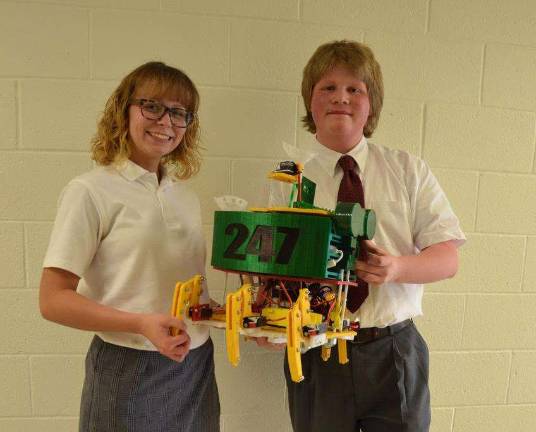 Pope John students to present at robotics conference From left, Gaige Moore and Evan Gagnon with Pope John XIII Robotic Team’s six-legged robot. Photo by frank Setlock