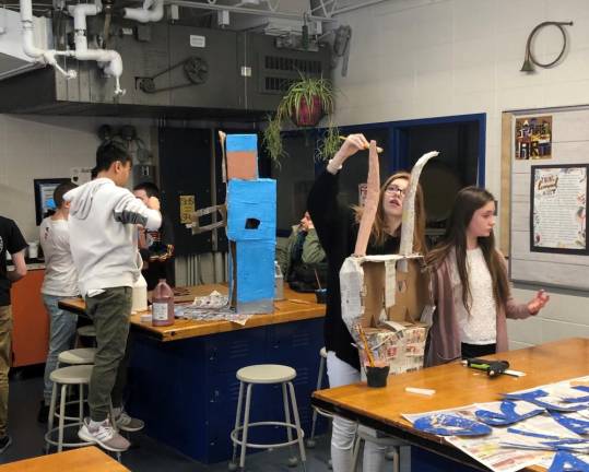 Abby Copolla, Cassis Yappan and Thinh Nguyen work on their projects.