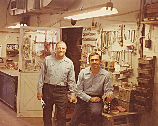 Auto body man bids farewell Father and son, Carmen Sr. and Carmen Jr. Scro, in the auto body shop, 1976.