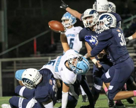 Running Back/Line Back Austin Castorina catches himself while holding the ball high for all to see.