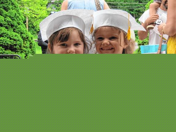 Preschool’s last graduation Amelia Arnone, 4, and Ava Pereira, 5.