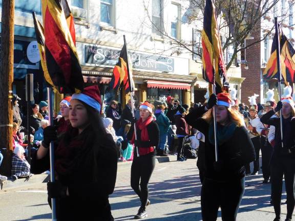 2019 Holiday Parade The Newton High School Marching Braves color guard leads the band up Spring Street in Newton during the Annual Holiday Parade on Saturday, Nov 30, 2019.
