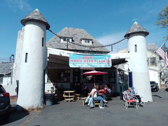 Compromise in sight for Sparta, Lake Mohawk Country Club Customers enjoy delicious ice cream treats as they sit on the patio of Alpine Creamery under a Save White Deer Plaza banner.