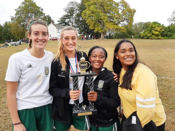 Veritas senior girls soccer players accept their championship trophy at the Garden State Association of Christian Schools tournament this past Fall.