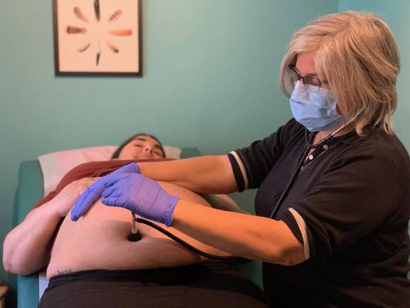 ‘We can’t help everybody’ Midwife Susanrachel Birdie Condon with her client, Anique Nicholson. Midwives wear N95 masks and gloves, but the reality is that some of us will become ill during this time, the midwives said in an open letter.