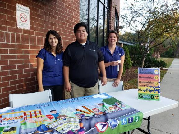 (Left to right): TransOptions representatives Lisa Leone, Jeremy Szeluge and Melissa McCutcheon await the arrival of walking students, ready to point out the benefits of walking to school.