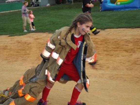 Nine-year-old Kyla Holmes trying her best at the firefighter race.