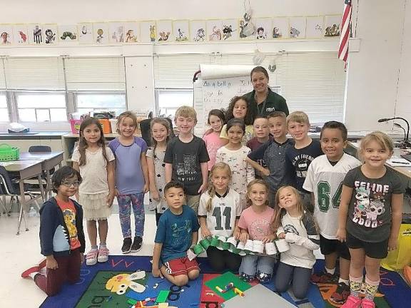 Students create paper chains on Kindness Day.