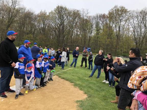 Parents photograph one of the Little League teams.