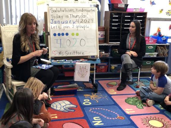 Tara Scrittore, left, does some basic math with her kindergarten students at Hamburg School. At right is paraprofessional Enza Ramos.