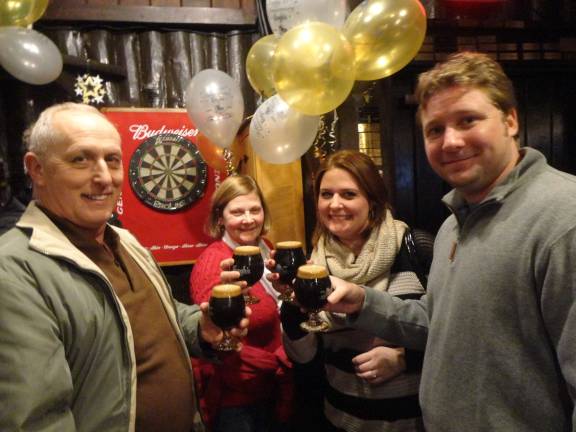 Krogh’s brewery celebrates 15 years with cave-aged brew Jeff and Diane Little, of Newton, and Kerstin and Matt Martinka, of Hampton, each enjoy a glass of Krogh's 15th anniversary Russian imperial stout.