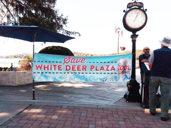 Banners strung over the boardwalk last weekend read “Save White Deer Plaza,” as business owners handed out free samples and collected petition signatures in support of allowing paid parking in the private lot owned by the Lake Mohawk Country Club.