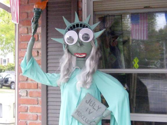 These dashing pumpkin heads await your visit Lady Liberty stands proudly on the porch of Tri-State Flagpole and Gifts (Photo by Janet Redyke)