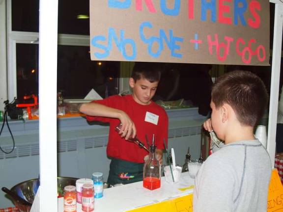 They mean business Miser Brothers co-ownerTravis Healy, 12, serves a customer a drink.