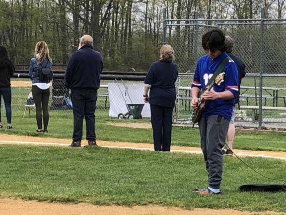 Drew Knec, a junior at Lenape Valley Regional High School, plays the national anthem on his guitar.