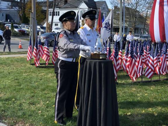 Members of the American Legion Post 86 Honor Guard toll the honor bell.